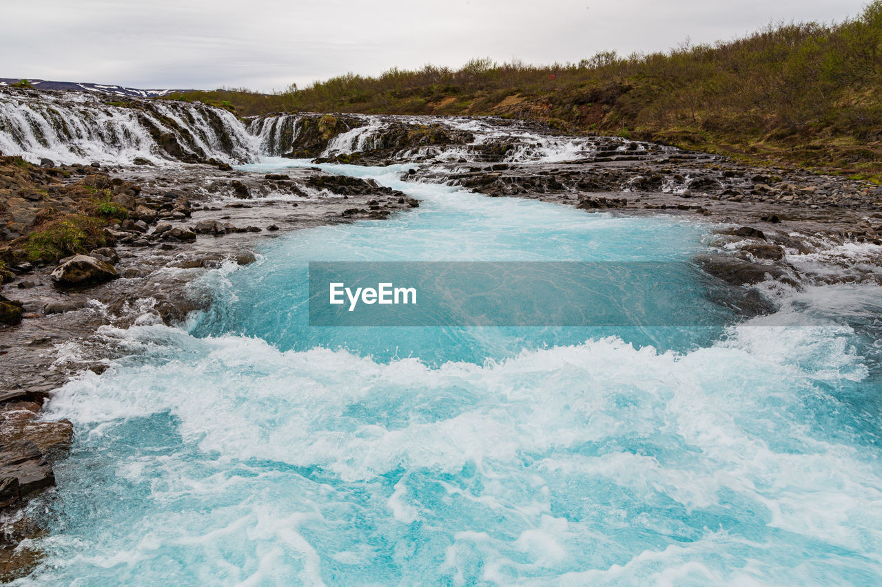 WATER FLOWING THROUGH ROCKS