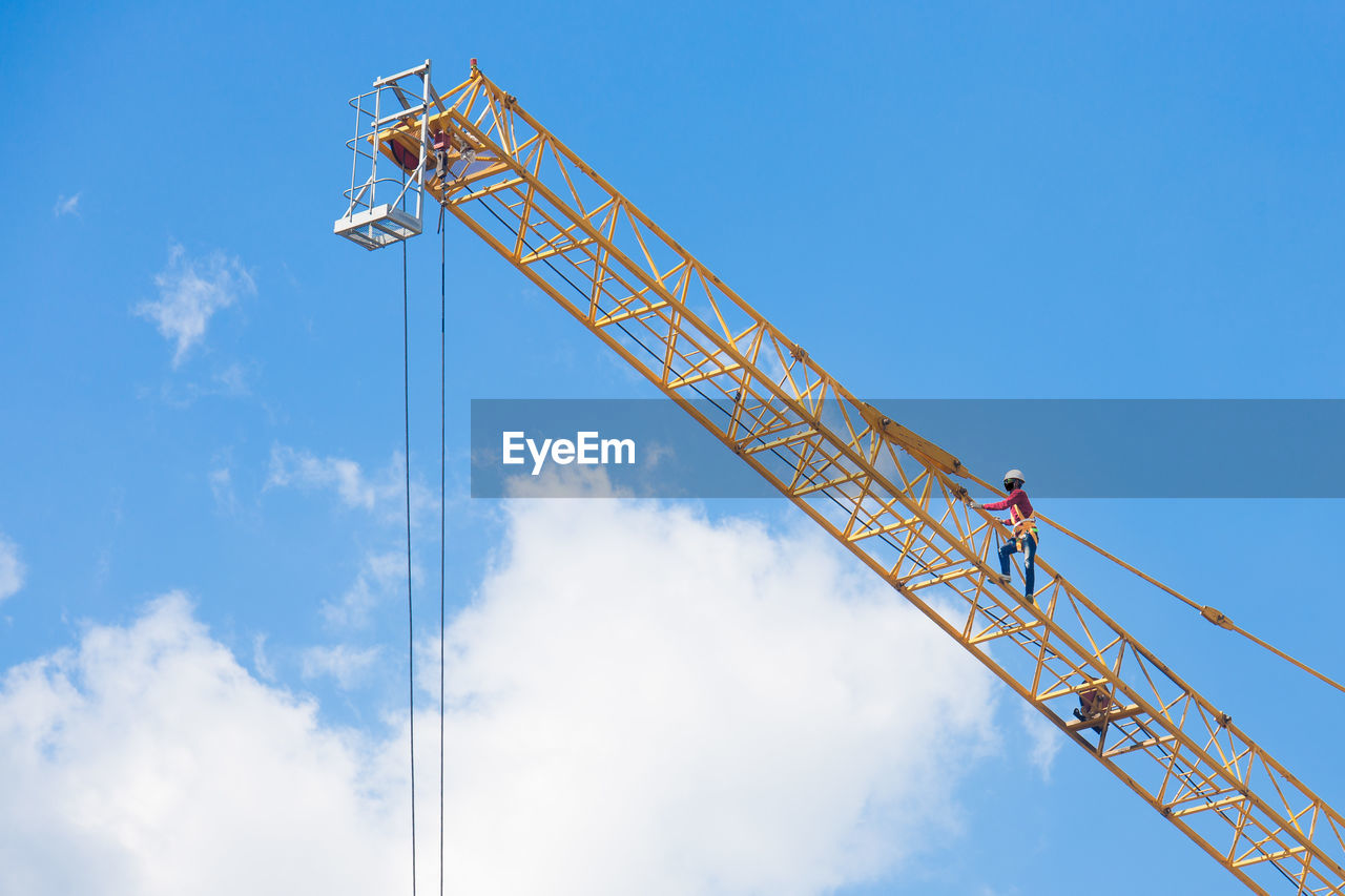 LOW ANGLE VIEW OF CRANE AT CONSTRUCTION SITE