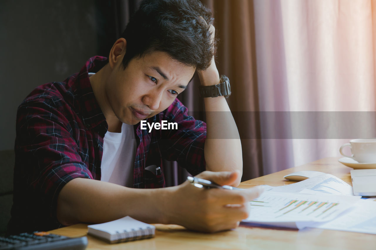 Stressed businessman working at desk in office