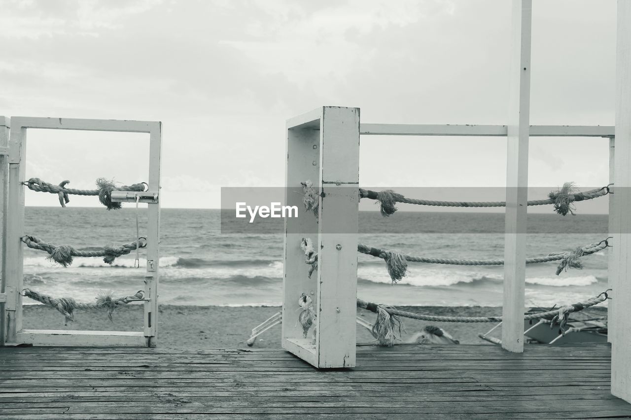 CLOSE-UP OF DECK CHAIRS AGAINST SEA