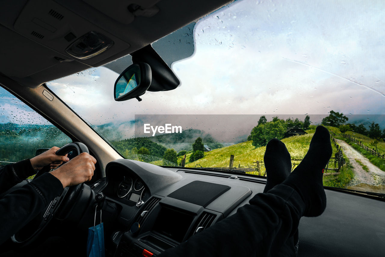 Man driving car on foggy mountain road in summer. people traveling by car