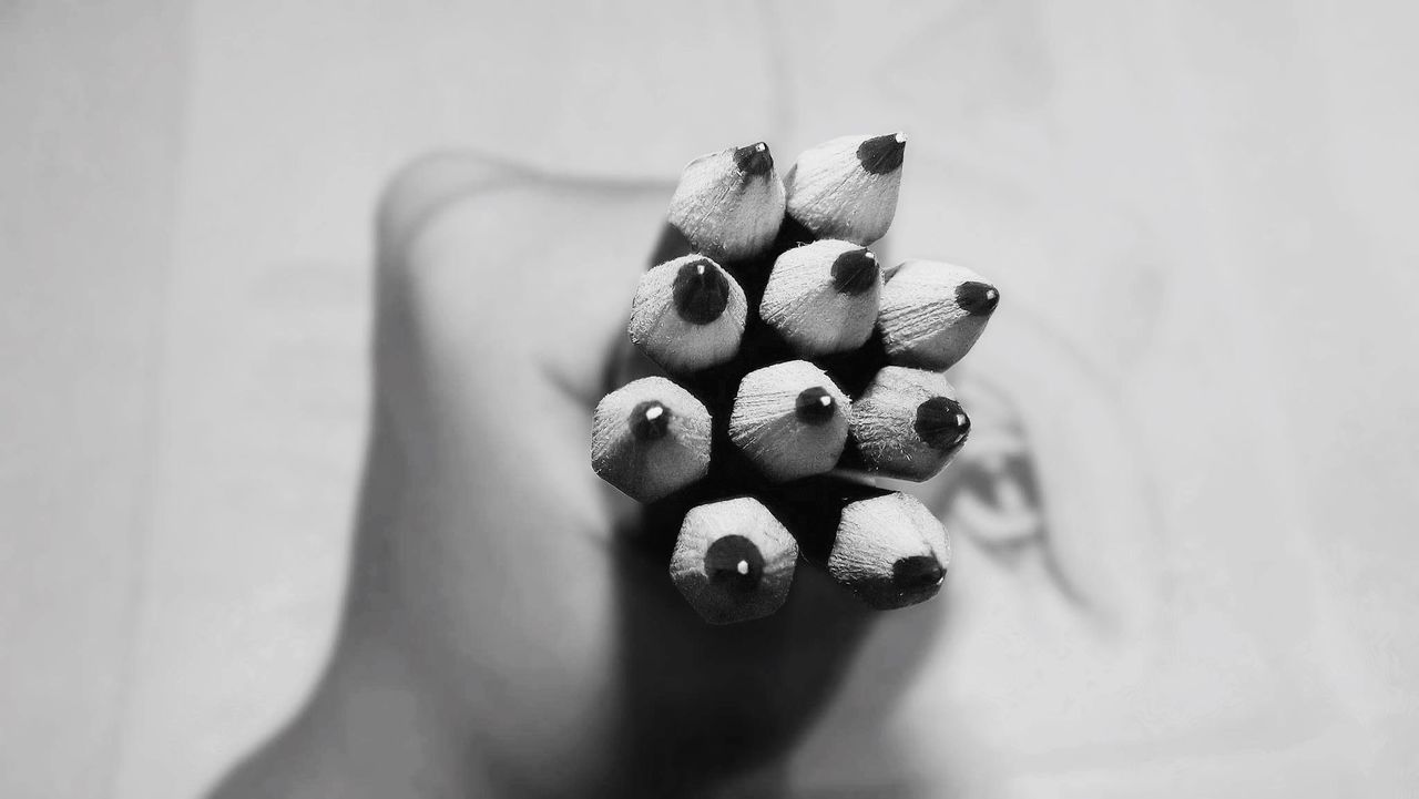 Close-up of hand holding pencils