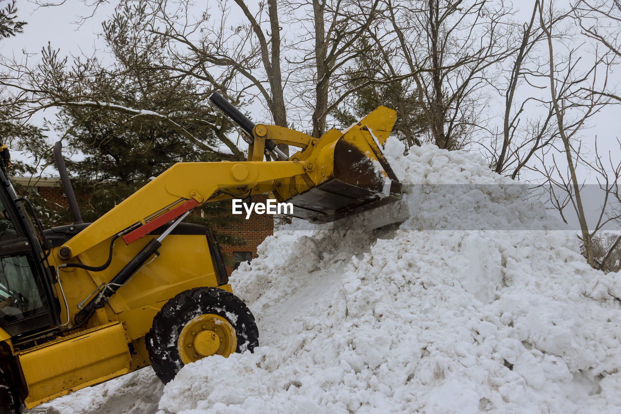 YELLOW CONSTRUCTION SITE ON SNOW