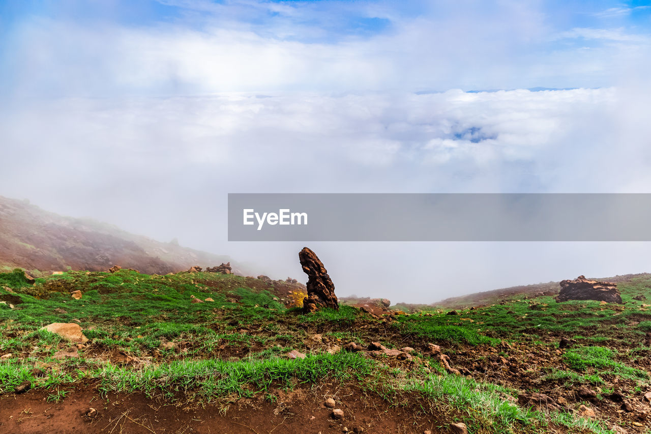 View on precipice hidden in fog and clouds near active volcano aso mount in kyushu, japan