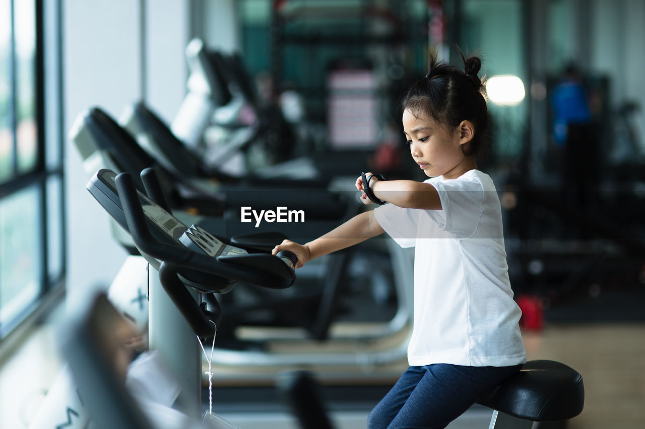 Cute girl exercising at gym