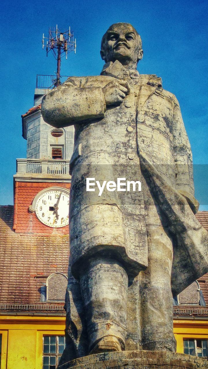 Low angle view of statue against building