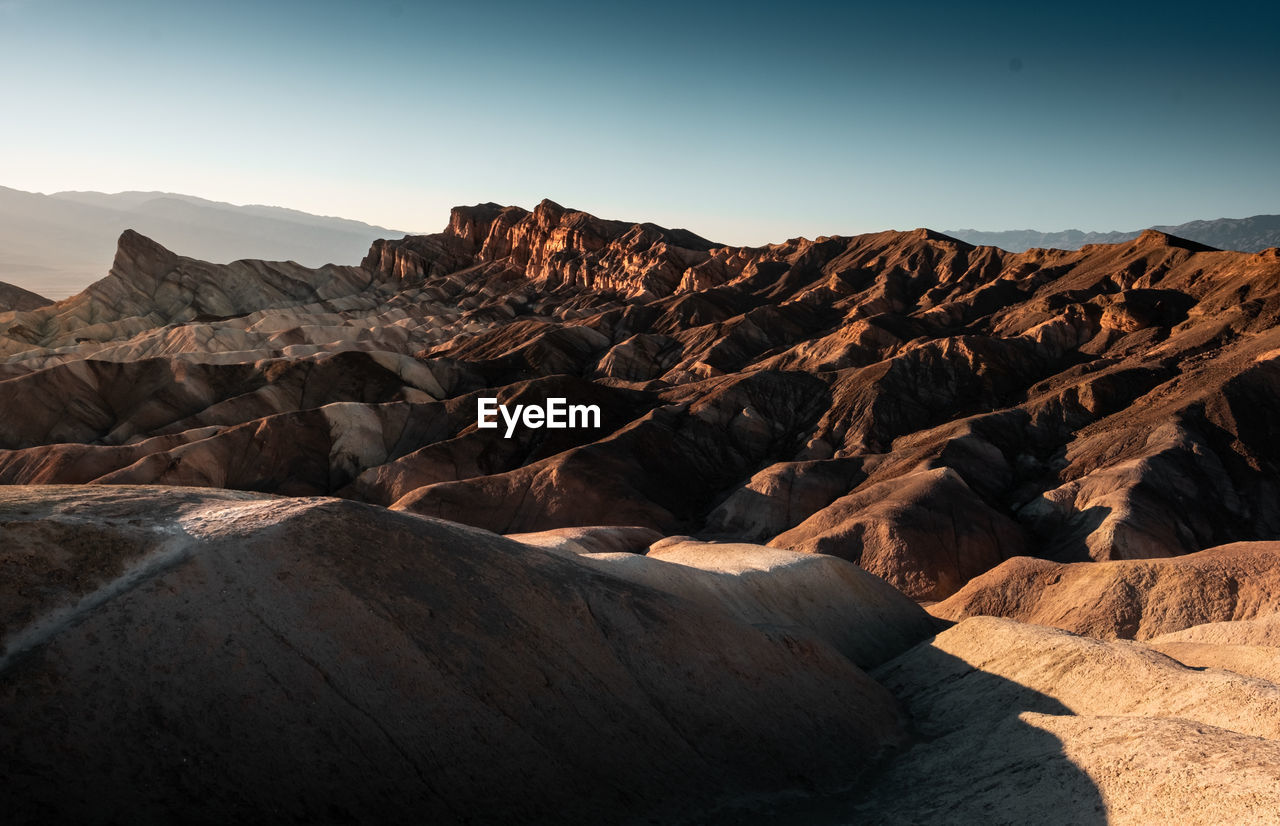 Scenic view of arid landscape against clear sky