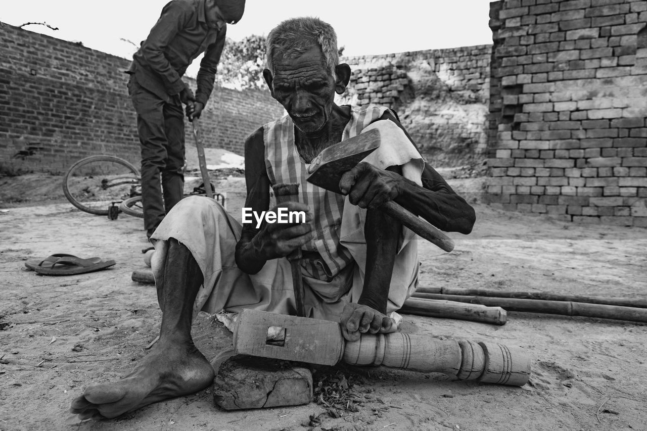 Old man trying to build a bed, old wood worker