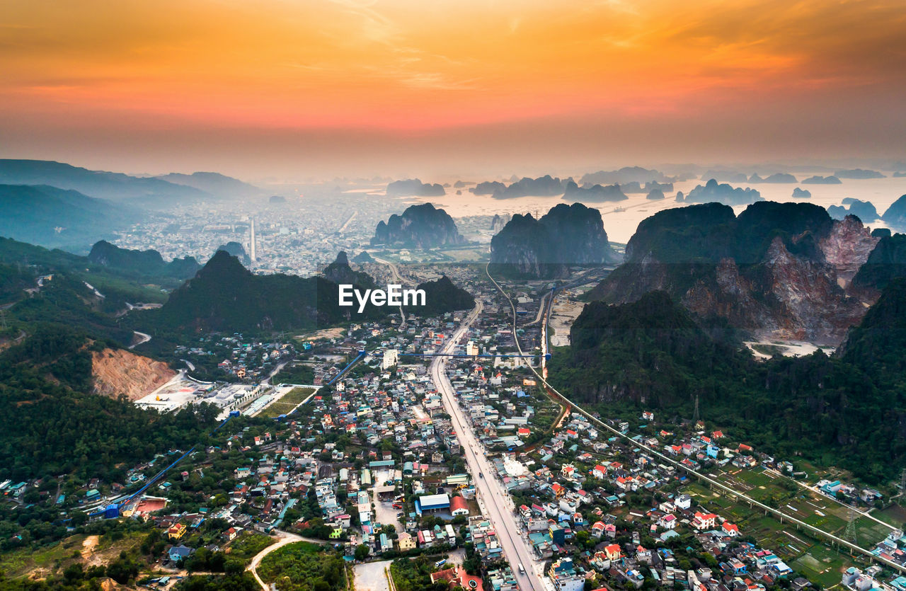 Aerial view of cityscape against sky during sunset