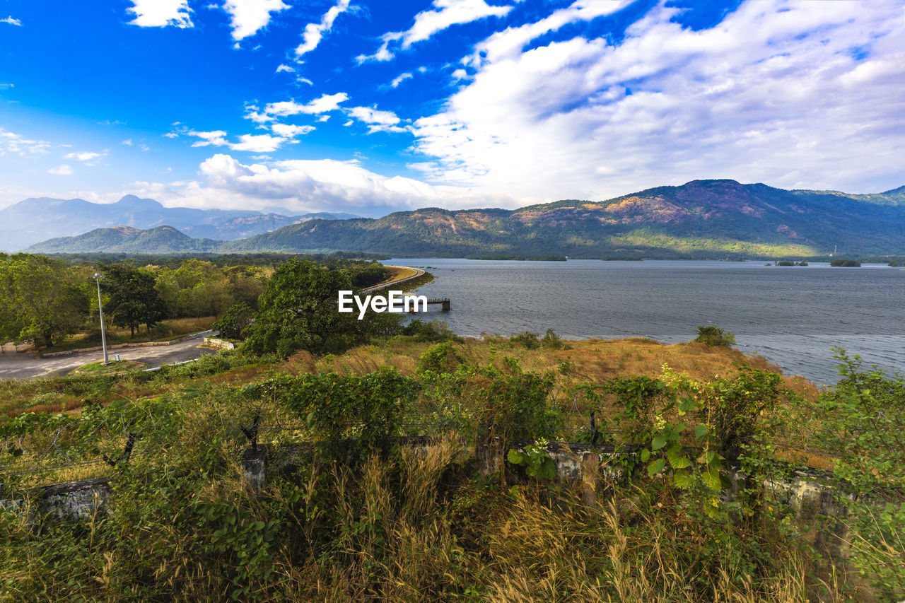 Scenic view of lake and mountains against sky