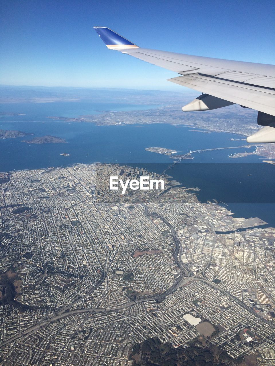 CROPPED IMAGE OF AIRPLANE WING OVER SEA