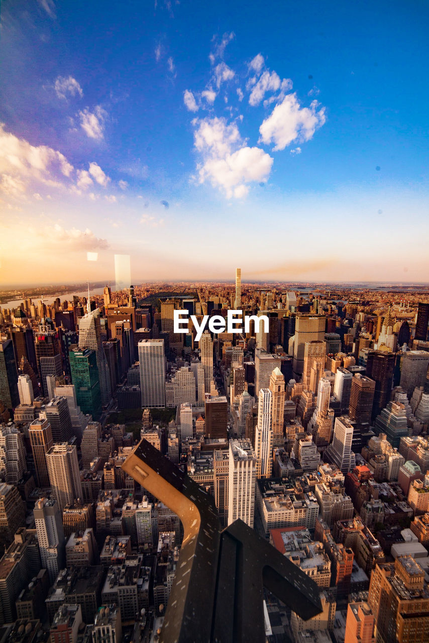 High angle view of cityscape against cloudy sky