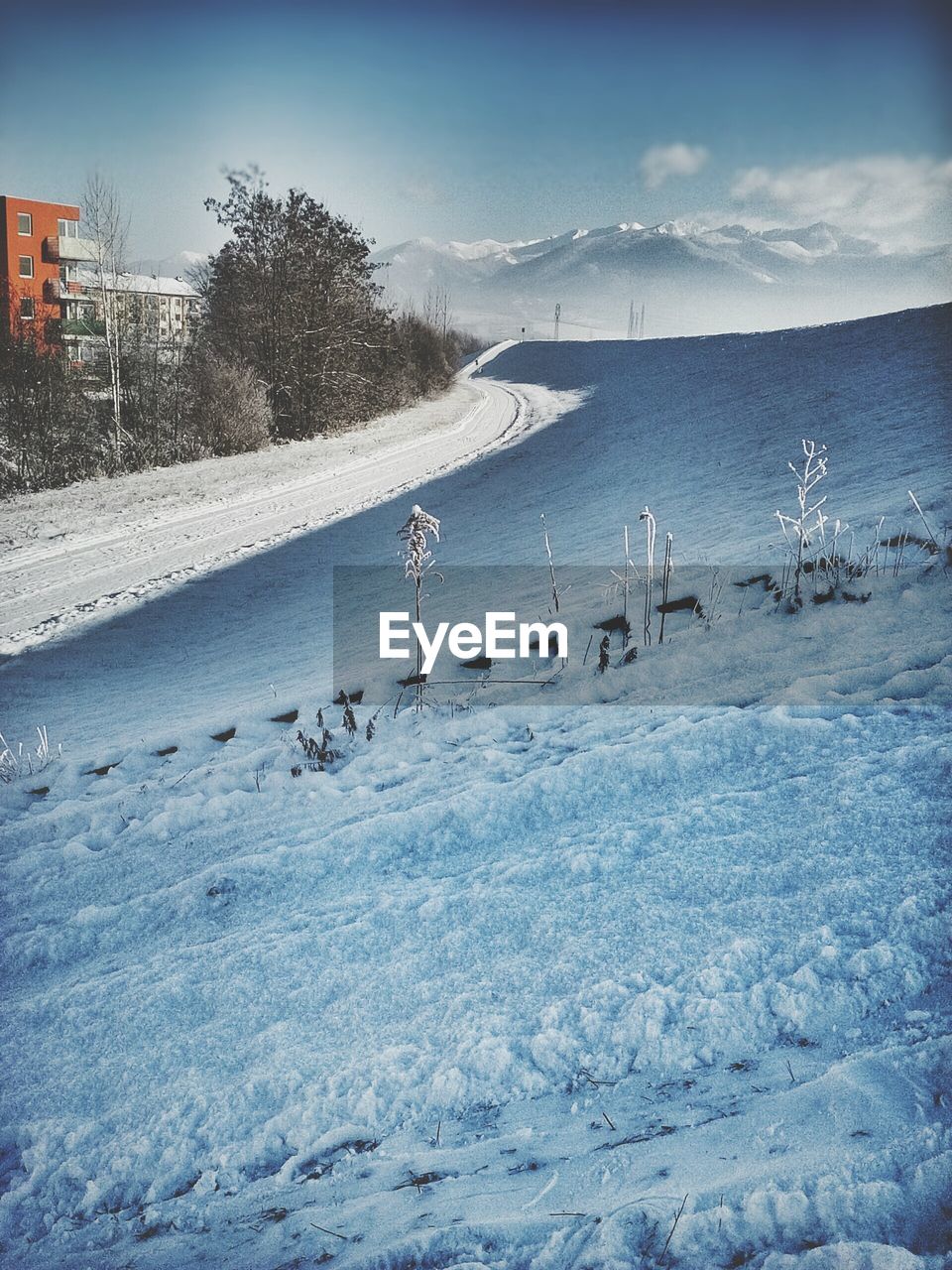 Snow covered landscape against sky