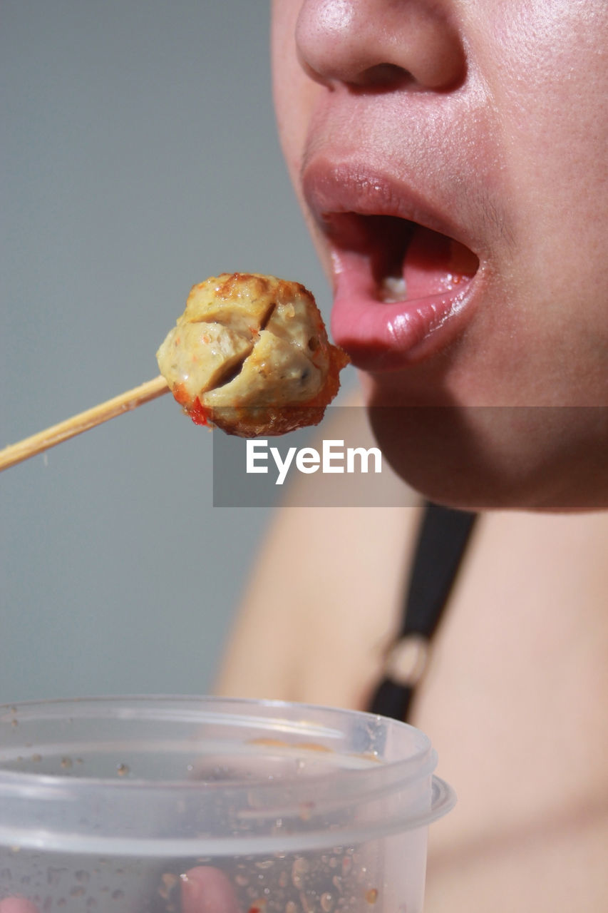 close-up of young woman holding ice cream