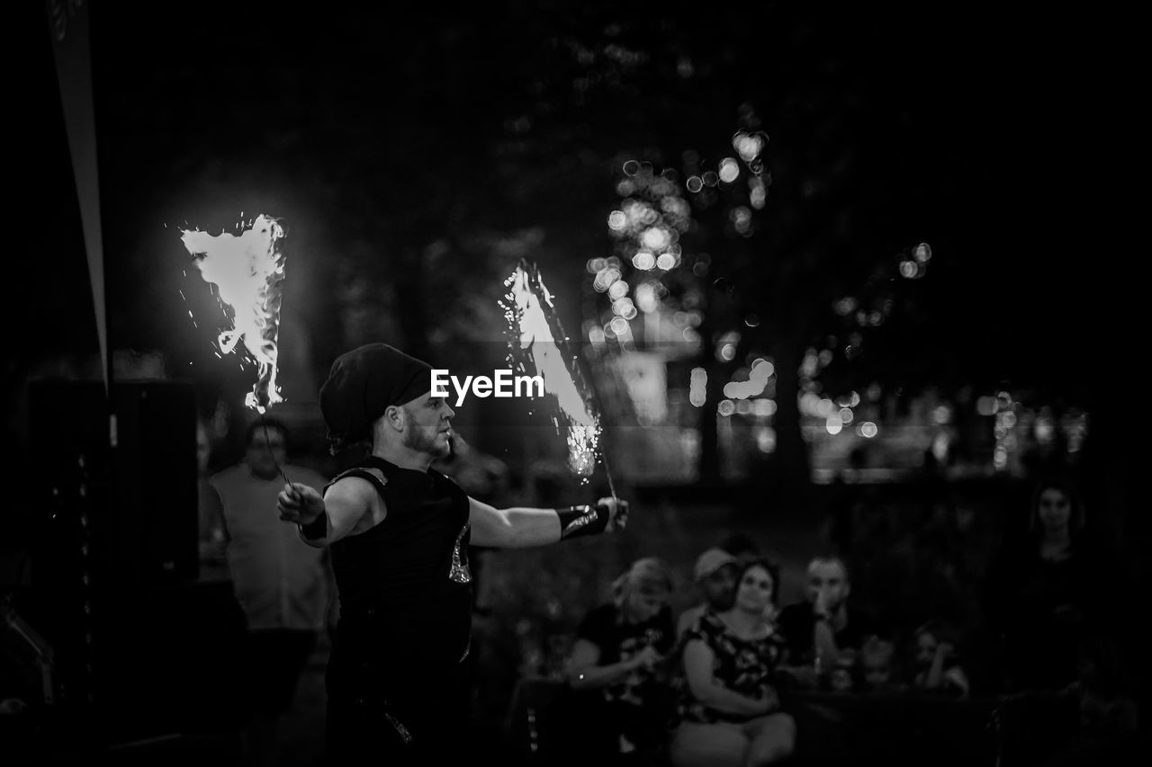 REAR VIEW OF PEOPLE ENJOYING MUSIC CONCERT