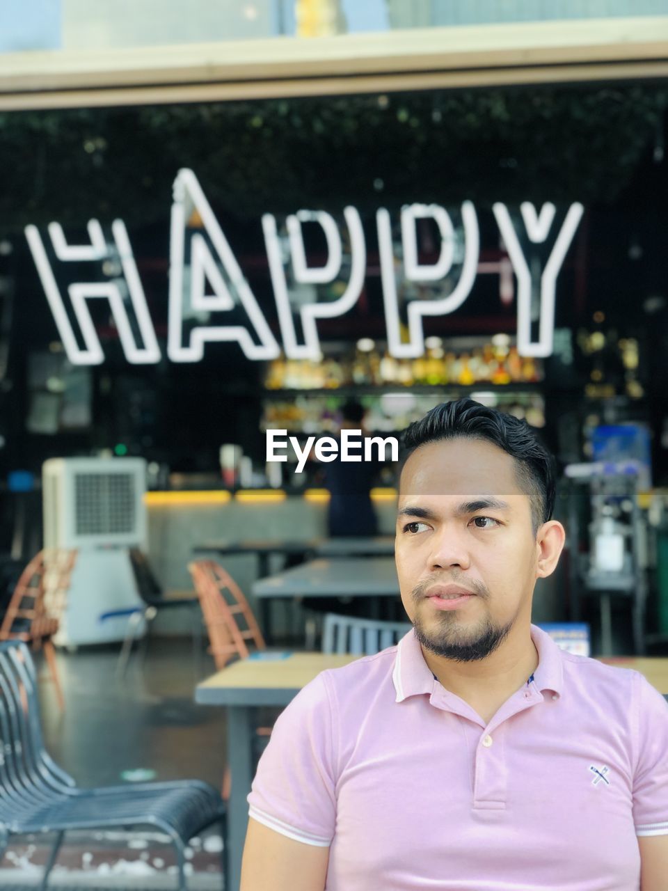 Portrait of young man sitting in cafe