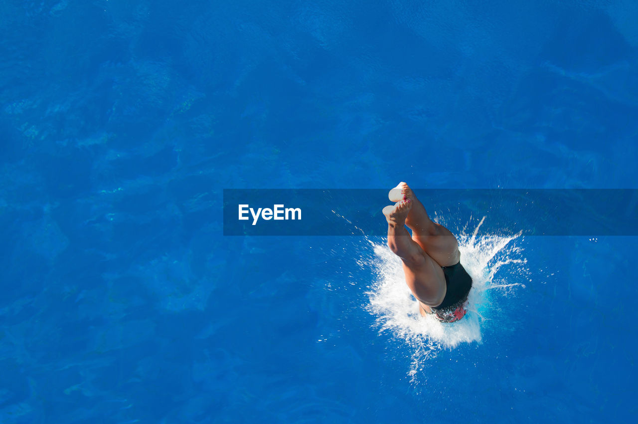 High angle view of mid adult woman diving in pool