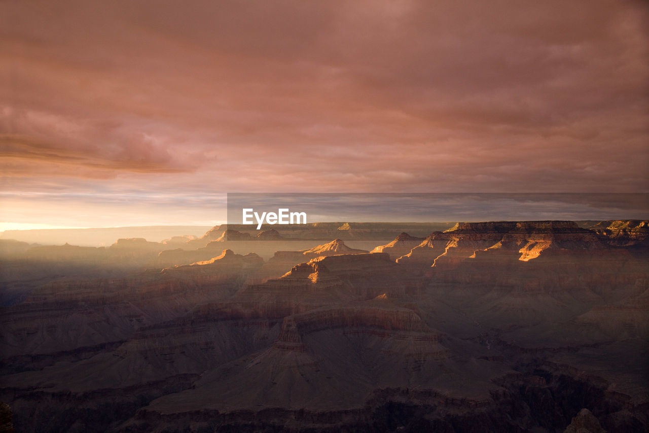 Dramatic sunset at grand canyon with orange and yellow sky