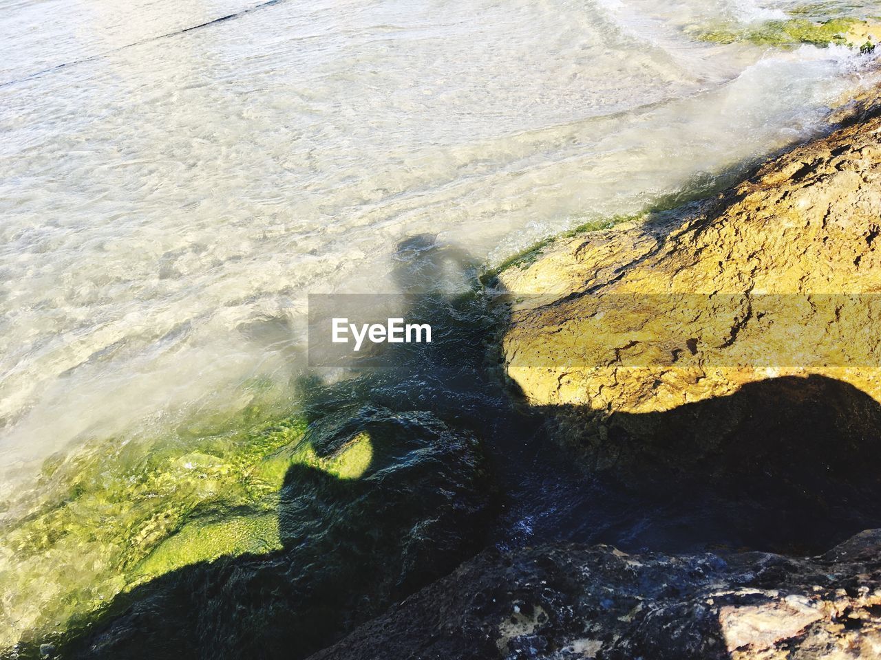 HIGH ANGLE VIEW OF SHADOW ON SHORE