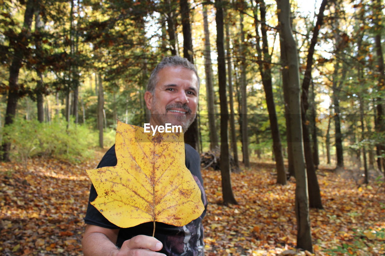 Portrait of smiling man in forest