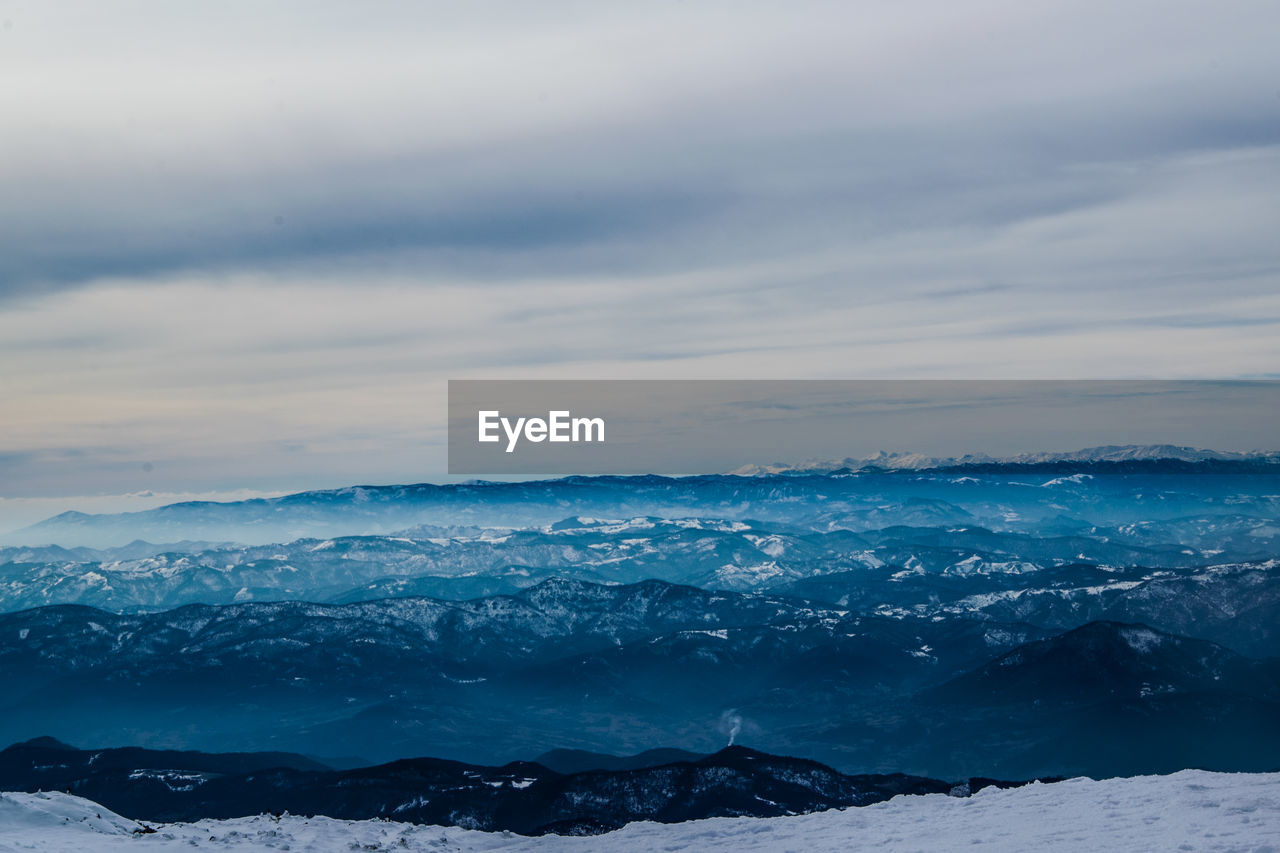 Scenic view of snowcapped mountains against sky