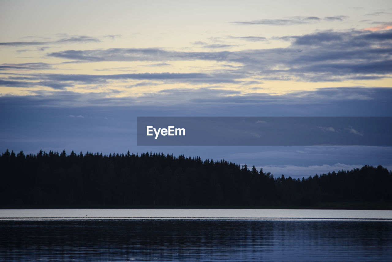 Scenic view of lake against sky at sunset