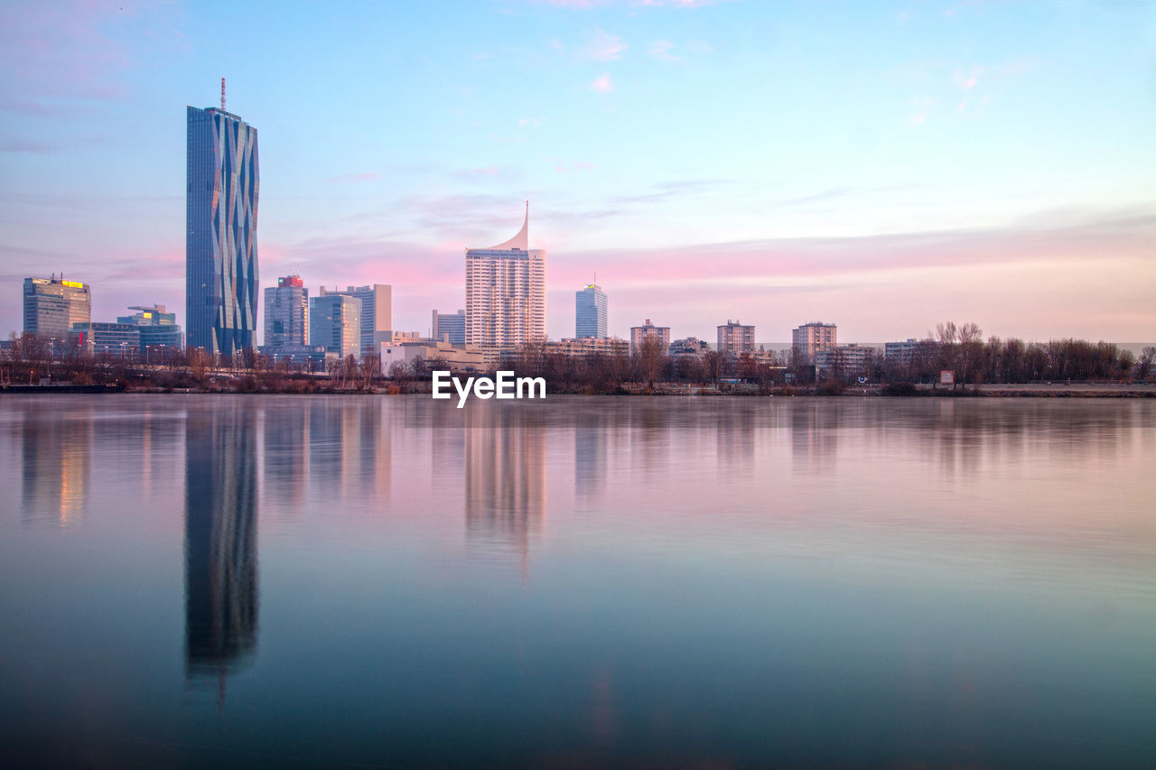 City at waterfront during sunset