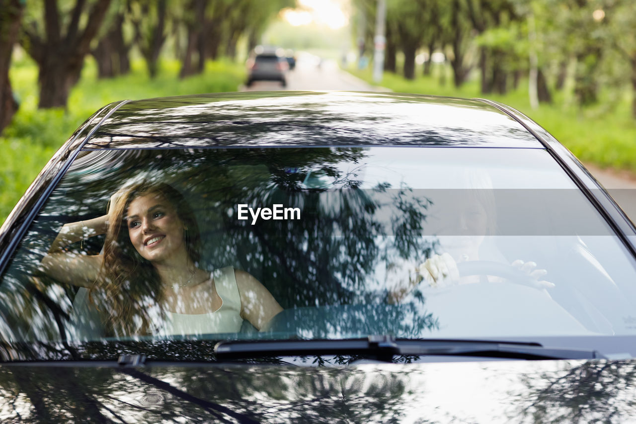 portrait of young woman sitting in car