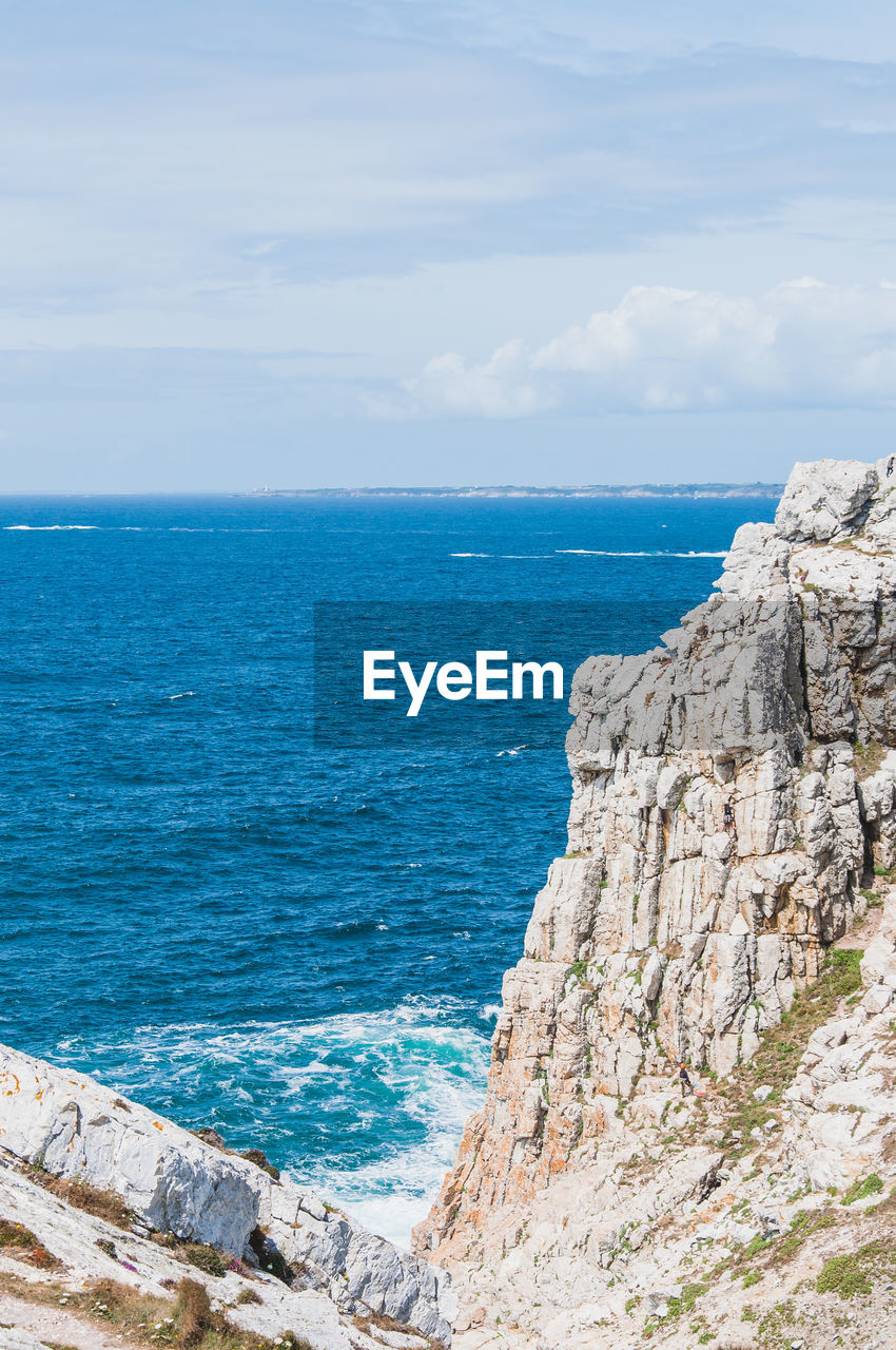 SCENIC VIEW OF SEA AND ROCKS AGAINST SKY