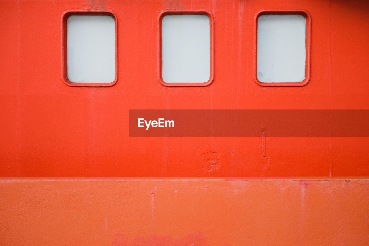 Full frame shot of windows on red wall