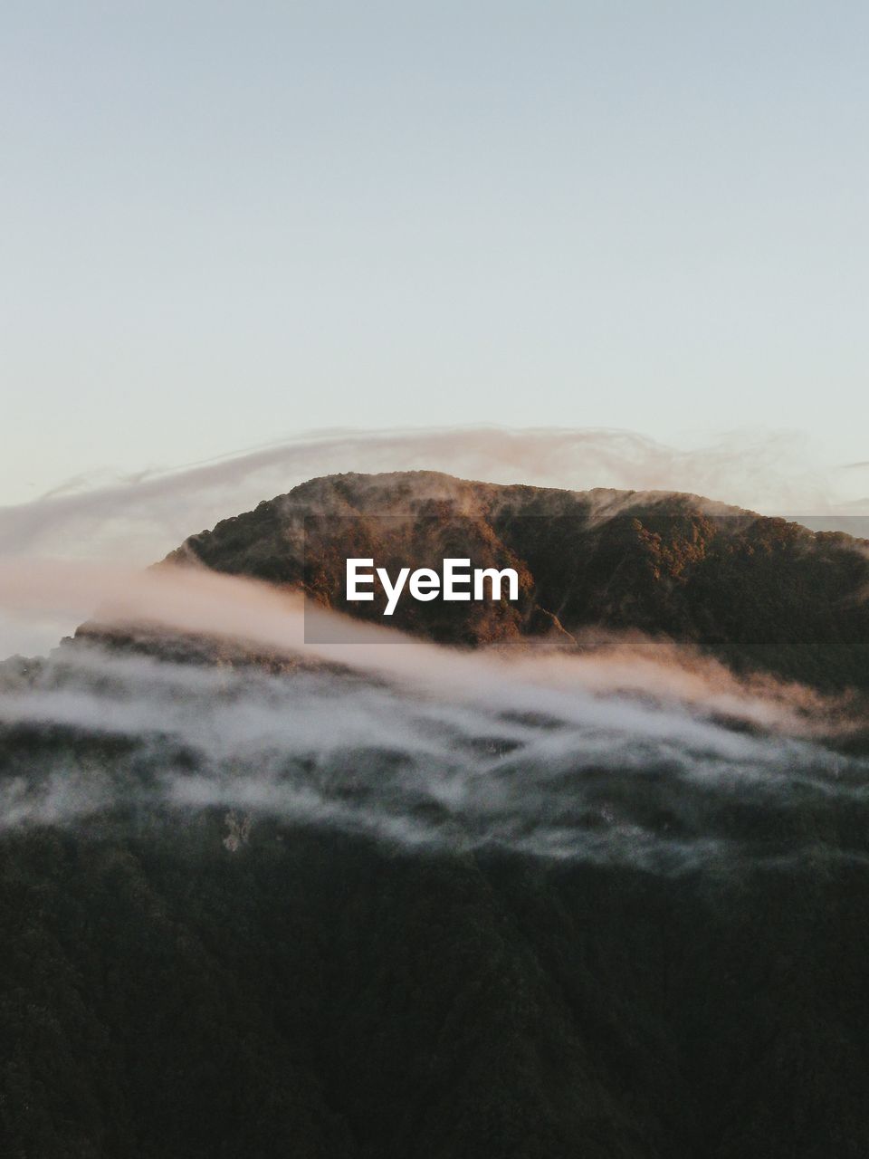 Scenic view of mountains against clear sky during sunset