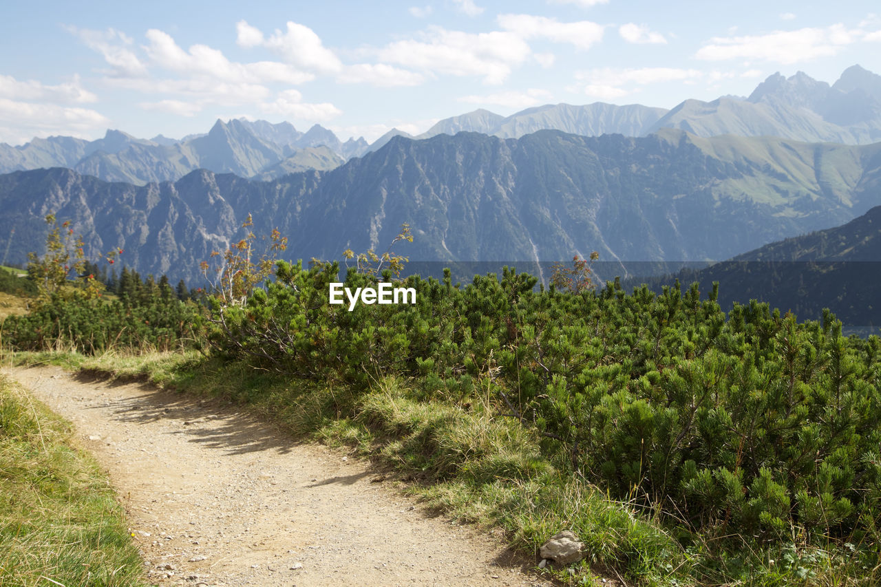 Scenic view of mountain range against cloudy sky