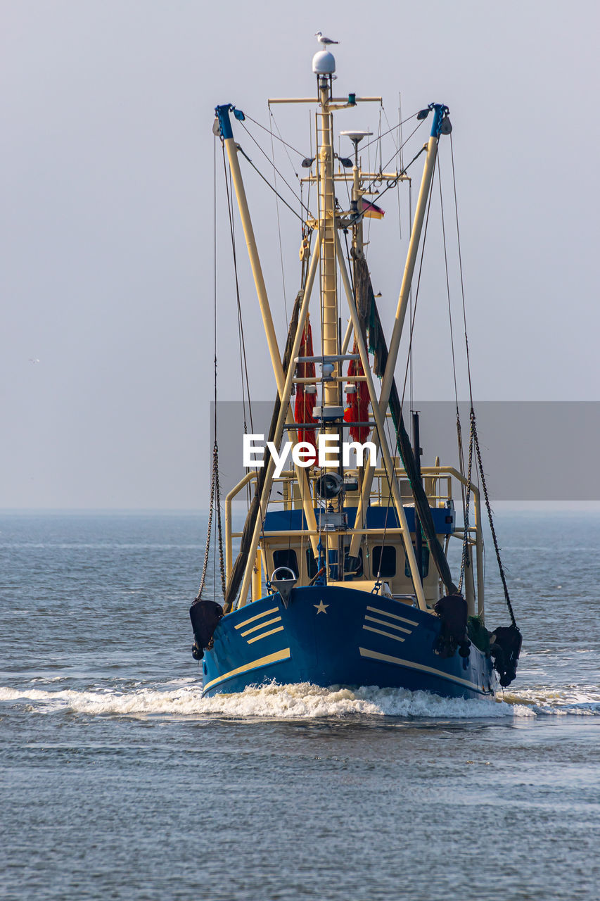 Sailboat on sea against clear sky