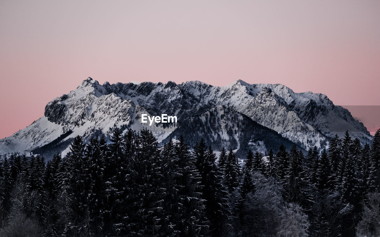 Scenic view of snowcapped mountains against clear sky