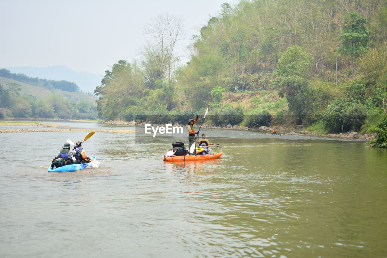 PEOPLE IN BOAT AT RIVER