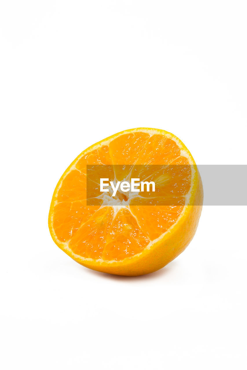 Close-up of orange slice against white background