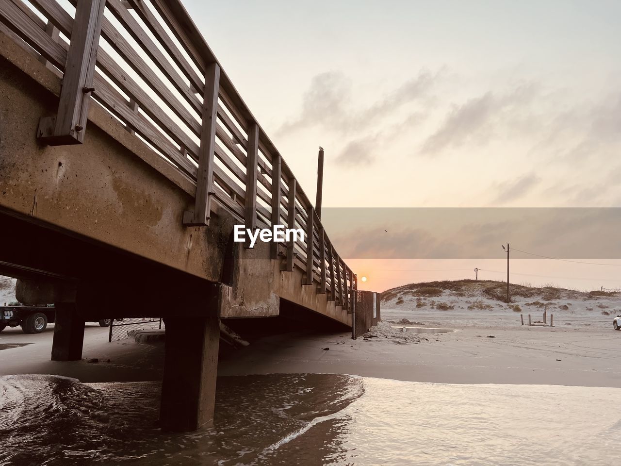 Pier at beach during a sunset 