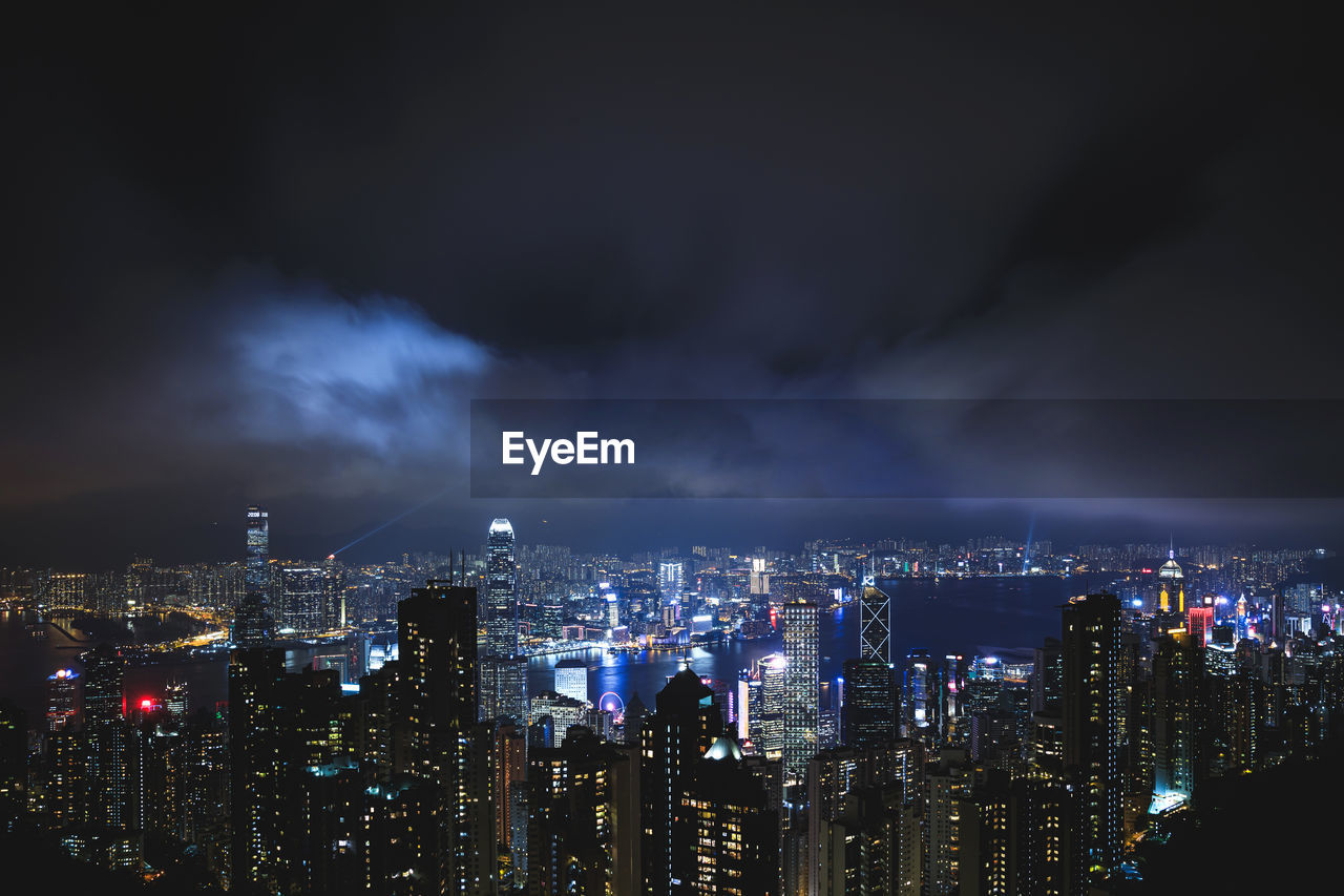 high angle view of illuminated buildings against sky at night