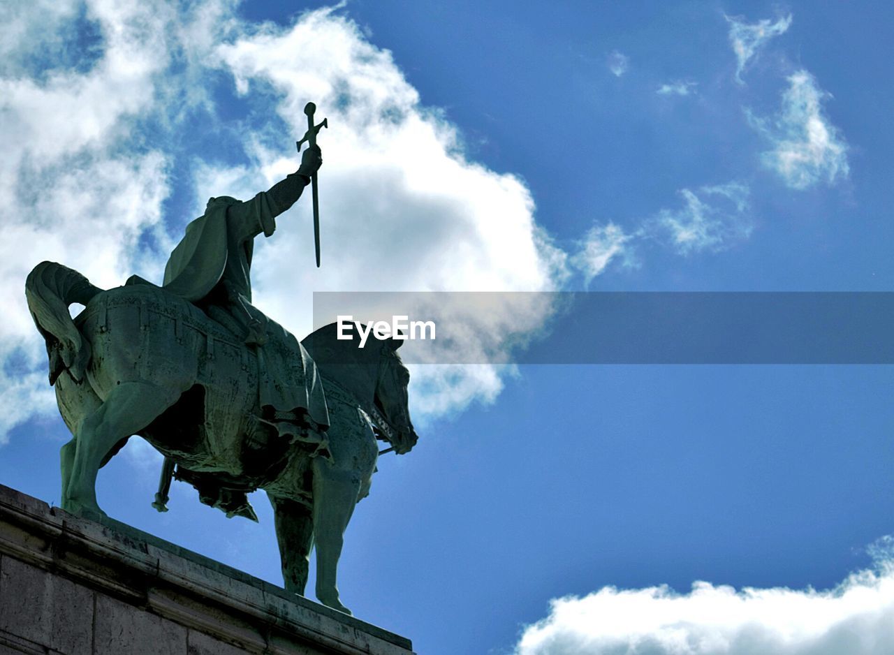 Low angle view of statue against sky