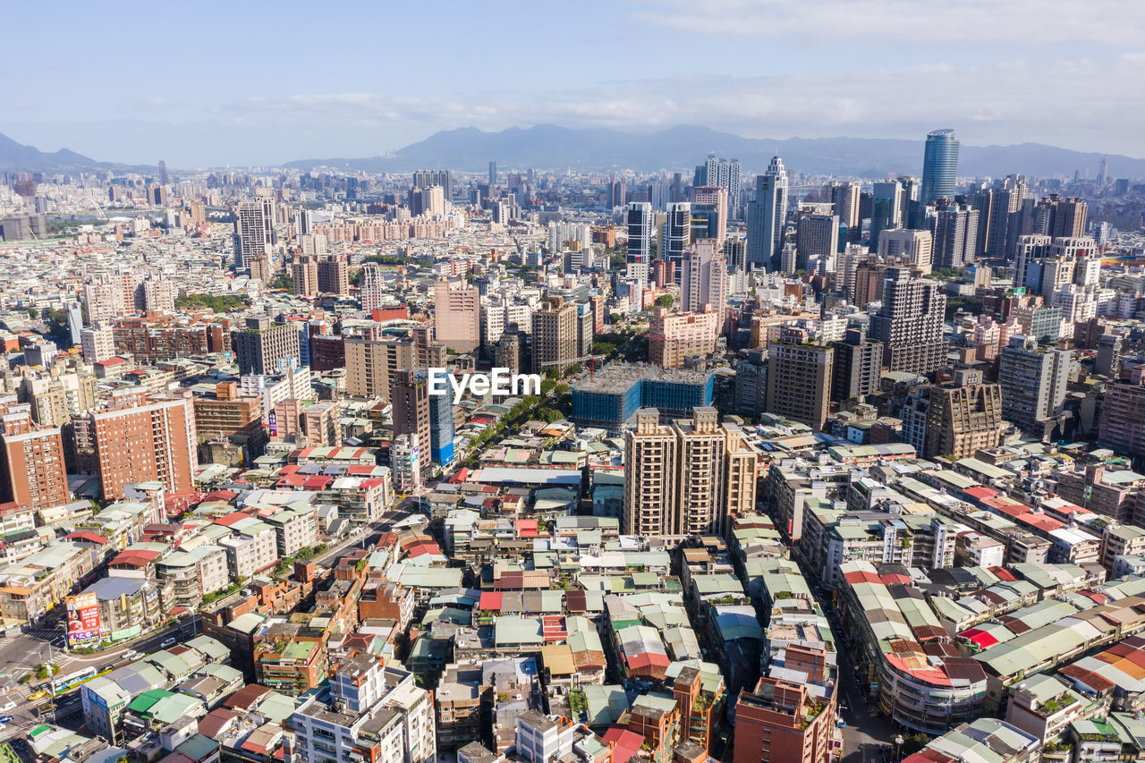 HIGH ANGLE VIEW OF MODERN BUILDINGS IN CITY