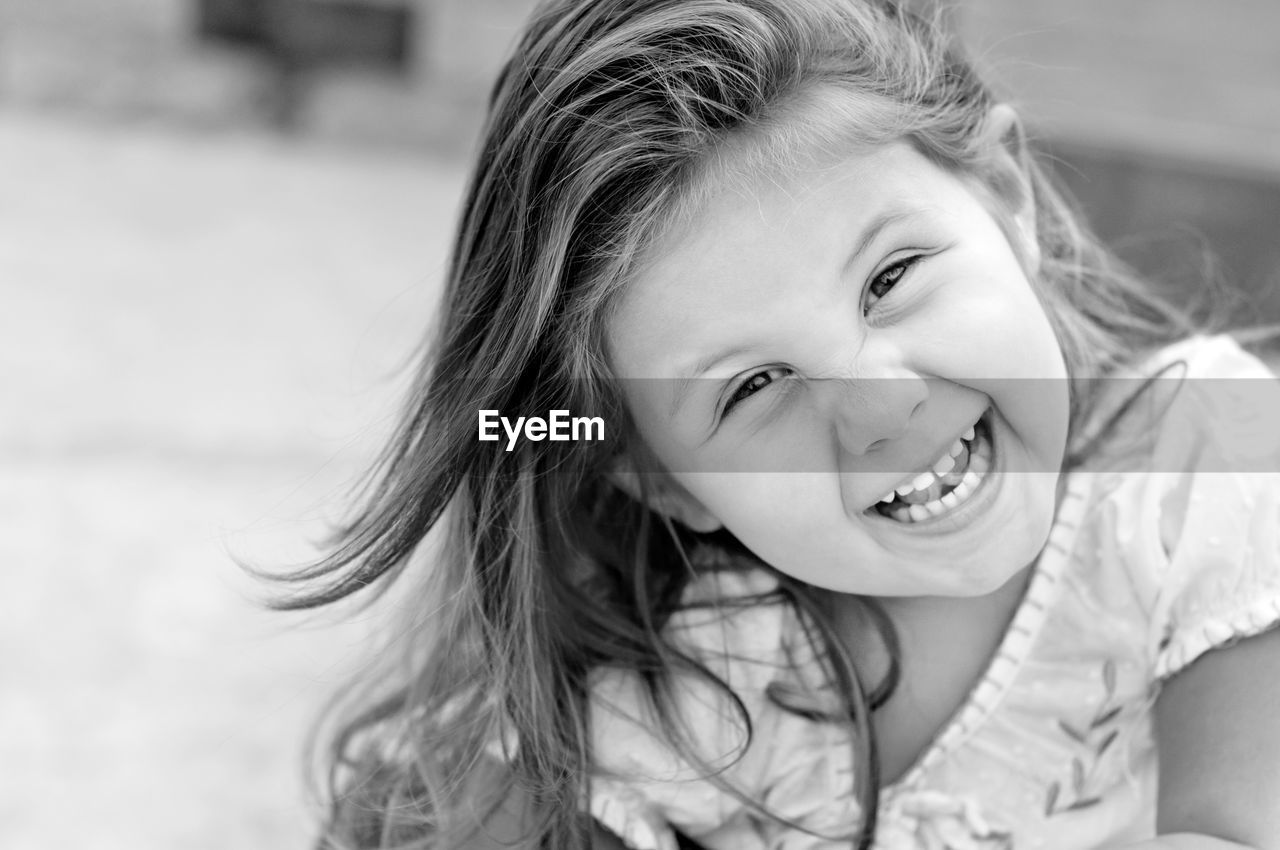 Portrait of cute girl smiling outdoors