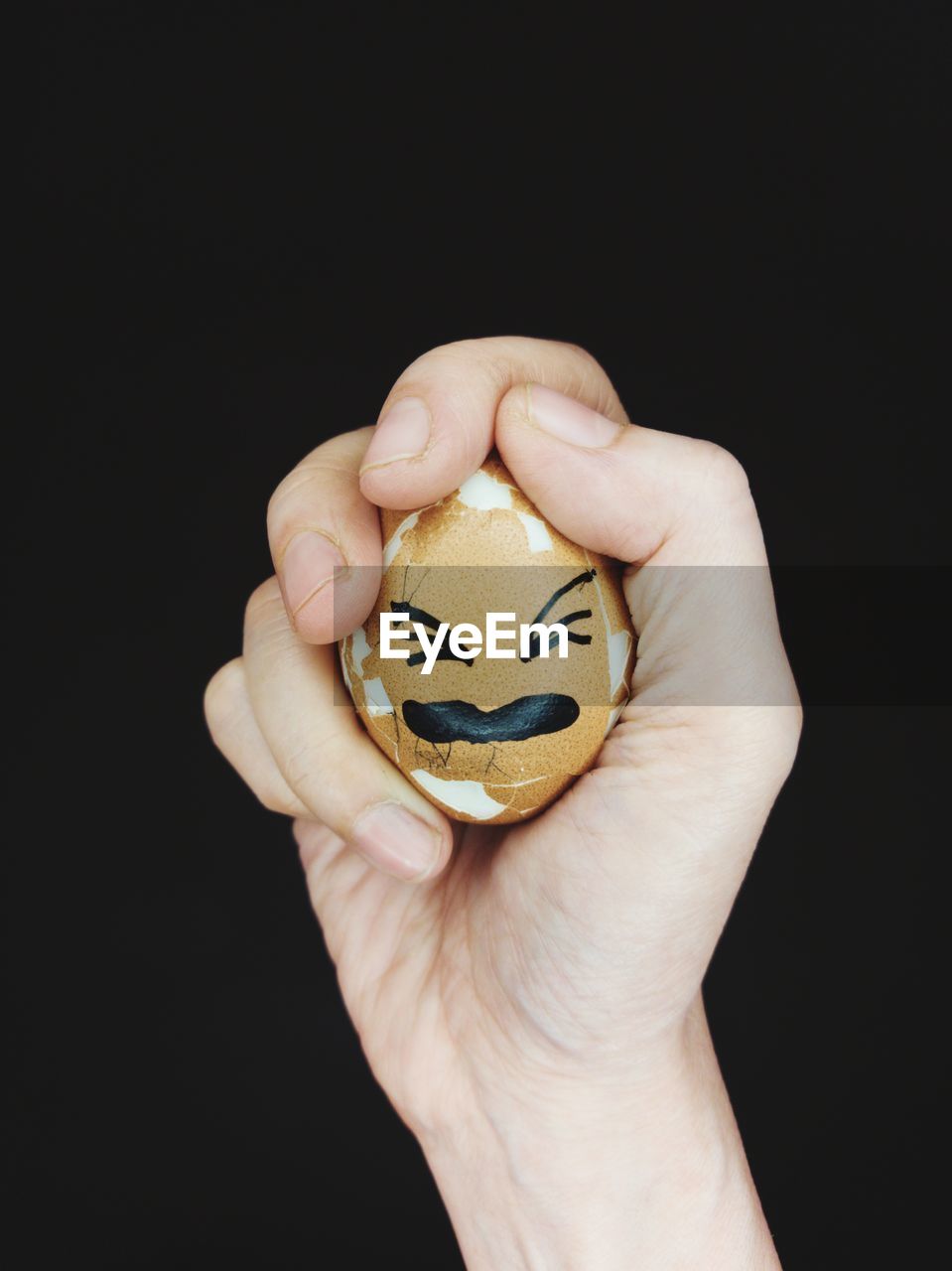 The egg in the hand.