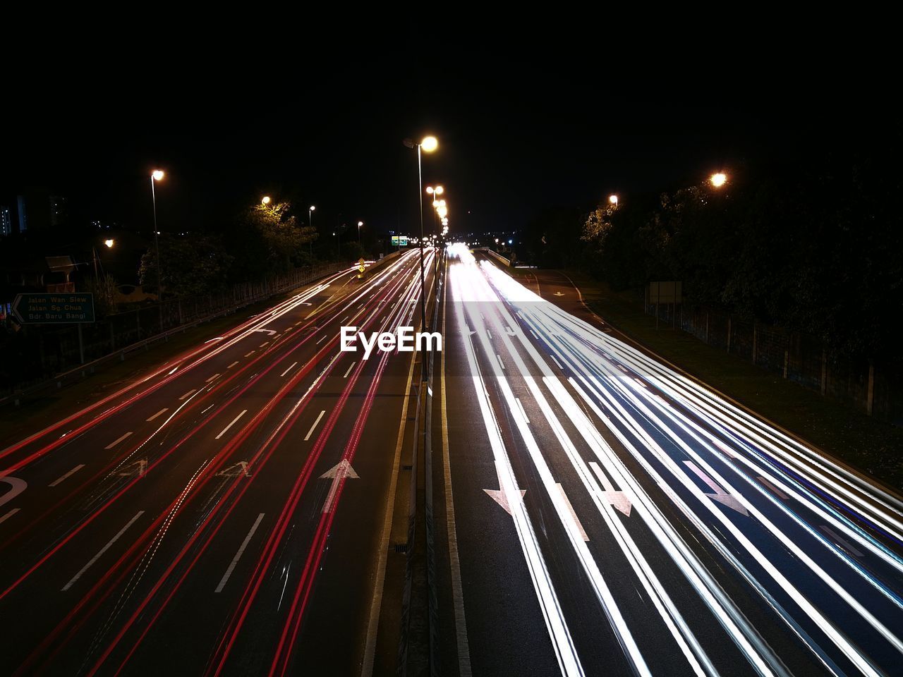 HIGH ANGLE VIEW OF LIGHT TRAILS ON ROAD IN CITY