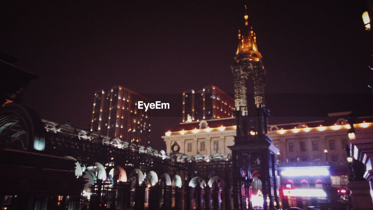 LOW ANGLE VIEW OF ILLUMINATED BUILDINGS