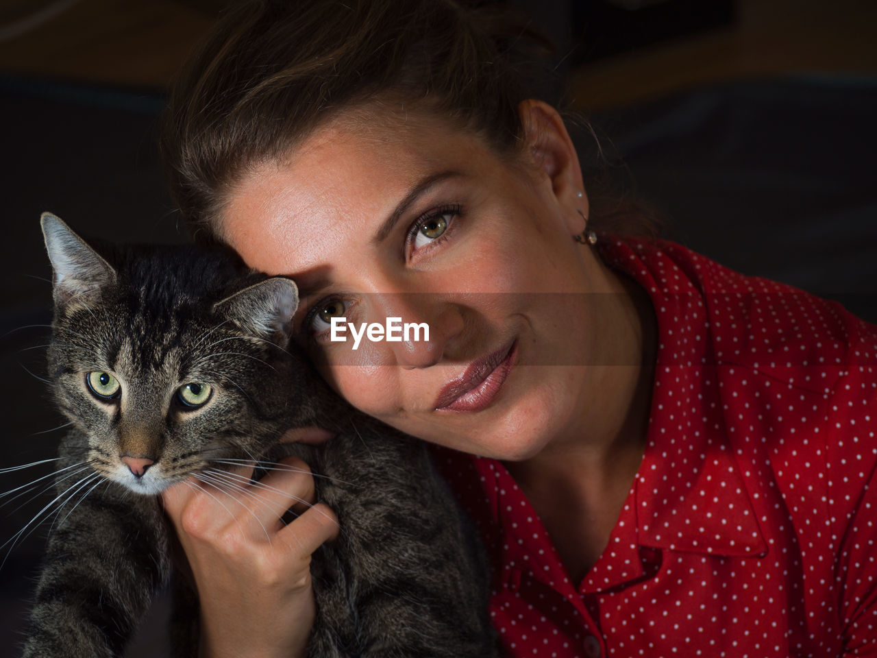 Portrait of smiling young woman with cat