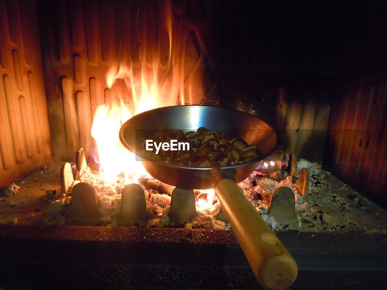 CLOSE-UP OF BURNING CANDLES ON GRILL