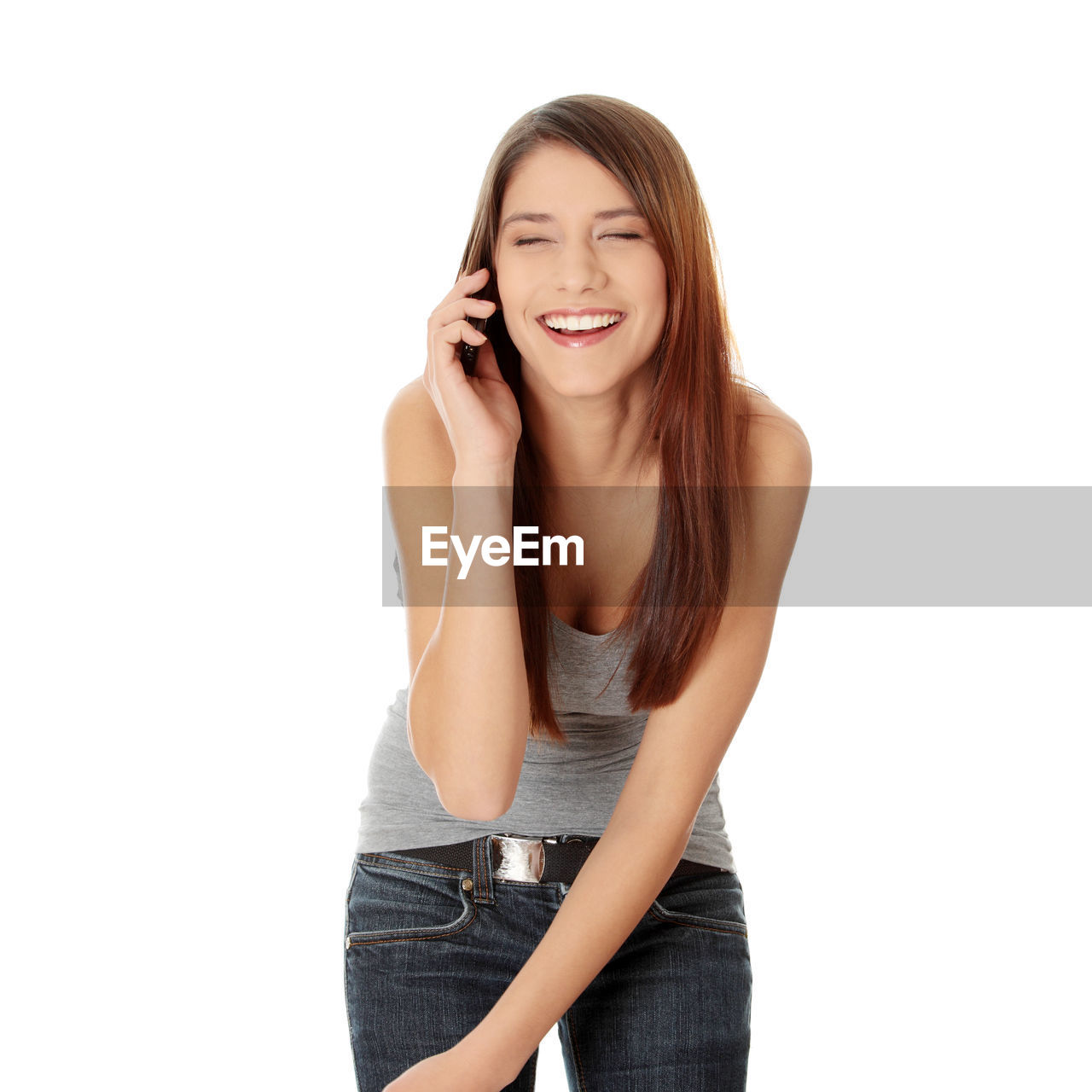 Cheerful woman using phone against white background