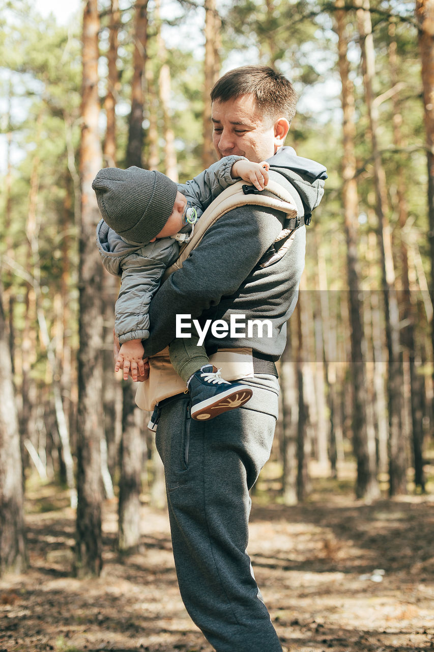 Side view of father with daughter in forest