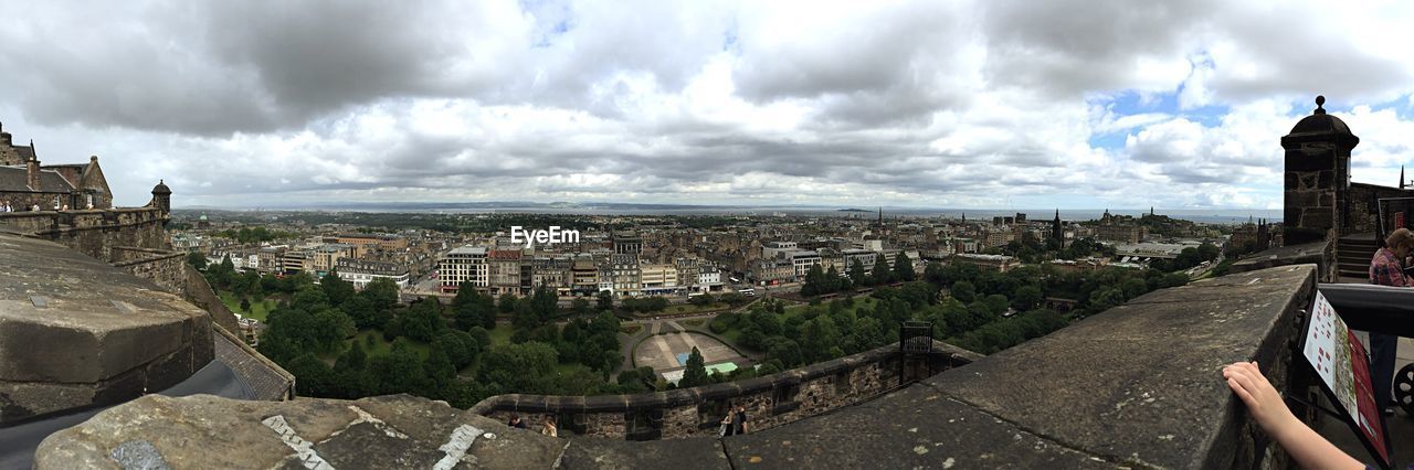 Panoramic view of cityscape against cloudy sky