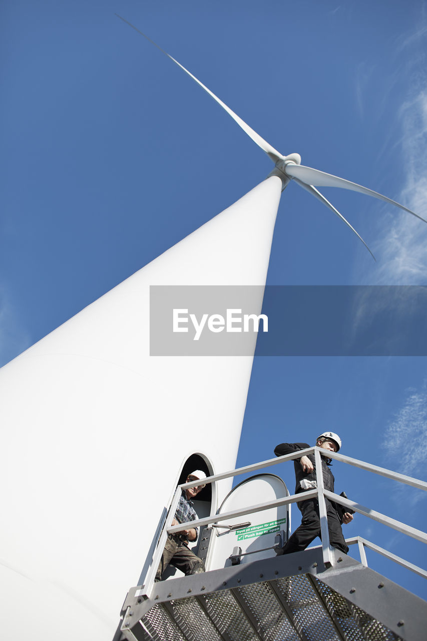 Engineers in front of wind turbine